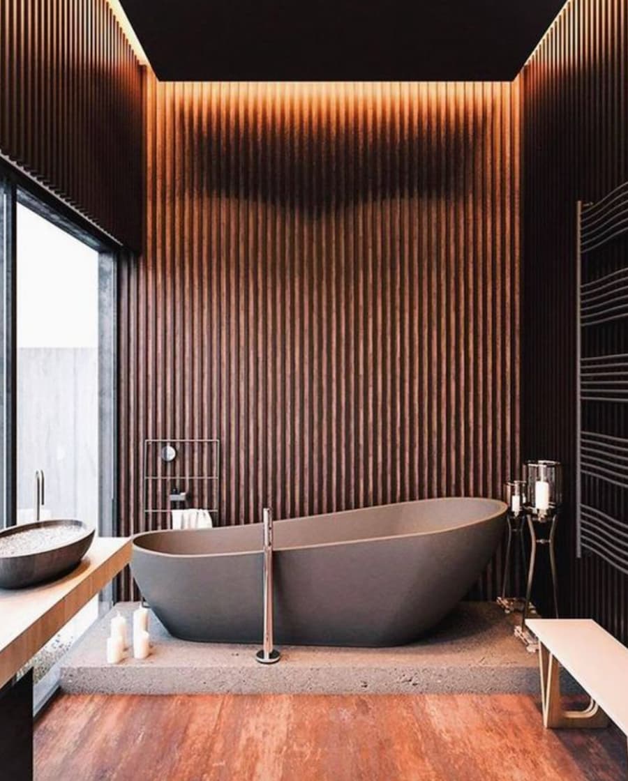 spa-inspired bathroom with dark brown feature wall and standalone bath