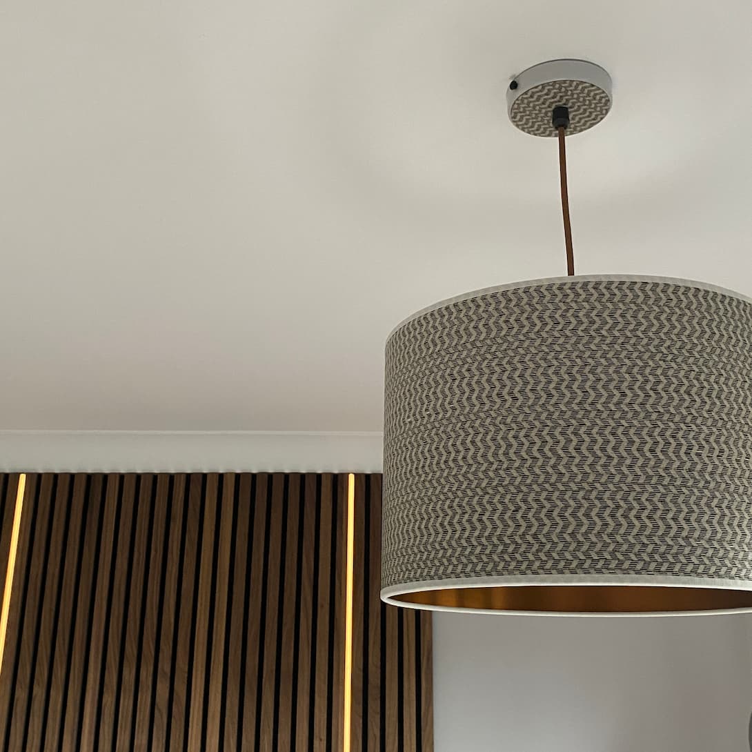 Handcrafted light pendant from Storm Furniture made from wood veneer with a herringbone pattern in off white and black