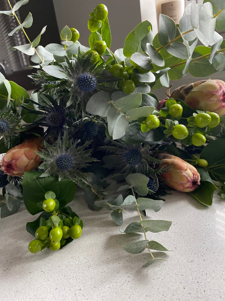 bunch of blooms consisting of eucalyptus and proteas