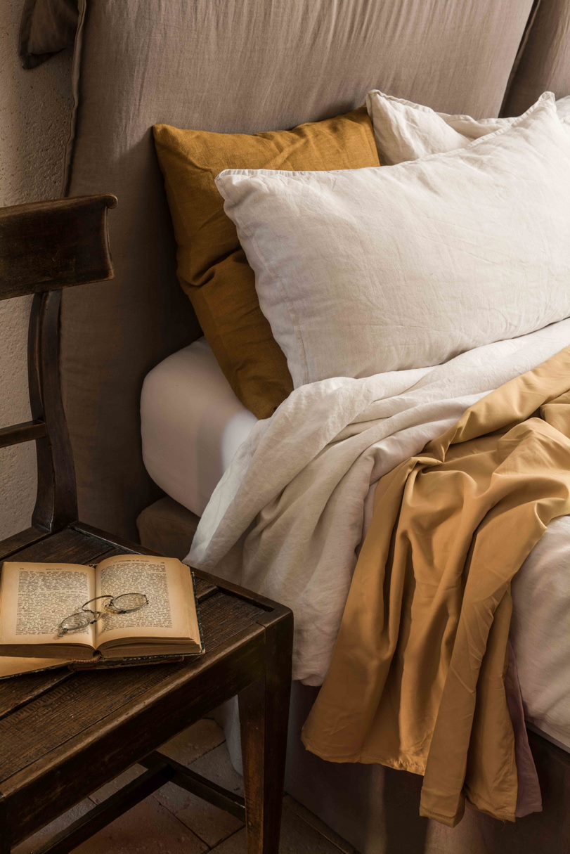 Minimalist styled bedrooms with beautiful refurbished vintage furniture. terracotta tiles and hand-sewn linens