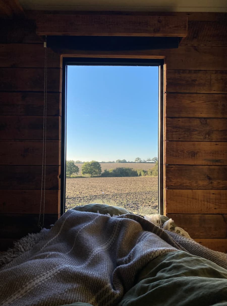 view overlooking fields from the bed of the shepherds hut