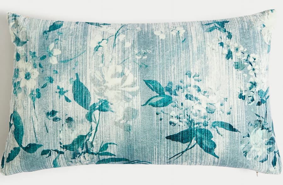 Floral designed bolster cushion in shades of blue