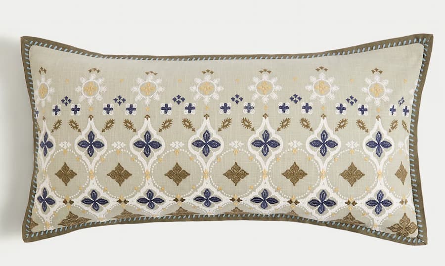 embroidered floral bolster cushion in neutral tones of beige and green